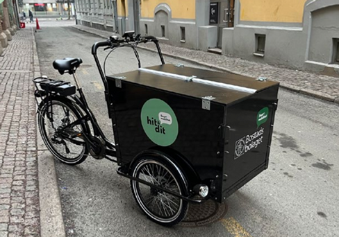 En lådcykel parkerad vid sidan av en gata.