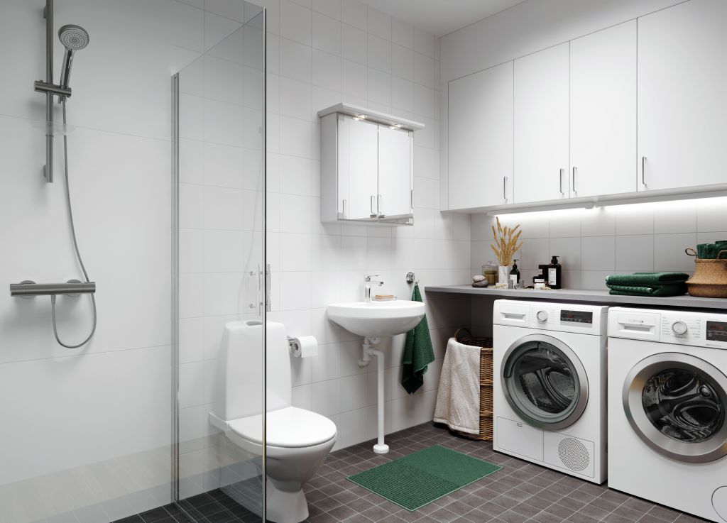Bilden visar ett badrum med tvättmaskin och torktumlare
